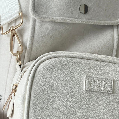 Detailed view of luxury ivory dog walking bag with multiple compartments